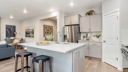Misty Meadows kitchen with island and painted shaker style cabinets with stainless steel appliances