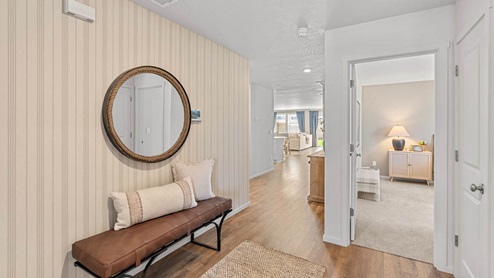 Addysen Park Entry with striped wallpaper and entry bench and round mirror
