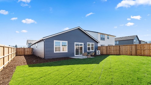 Addysen Park backyard with patio furniture and grass