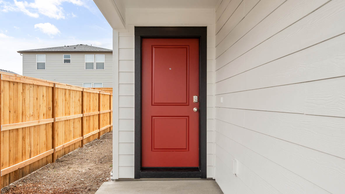 Addysen Park Entry with red door, and white siding