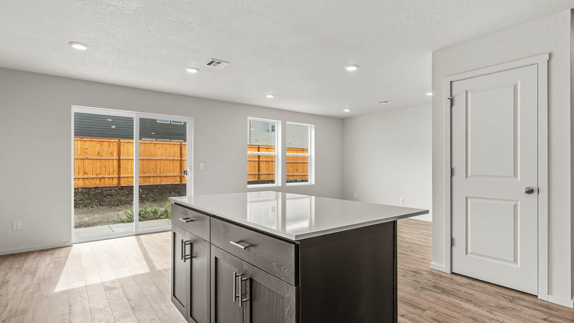 Addysen Park Kitchen with laminate flooring, painted white walls, window, kitchen island, countertops, cabinets