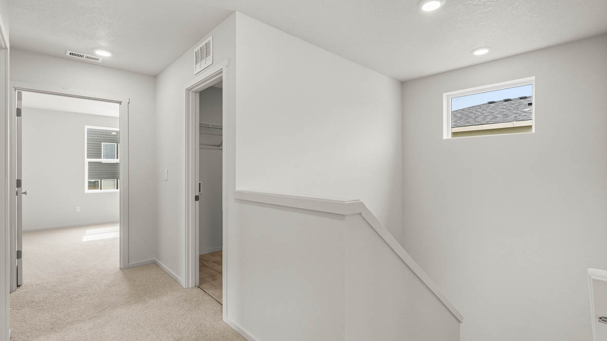 Addysen Park Upstairs hallway with carpet, window, and white walls