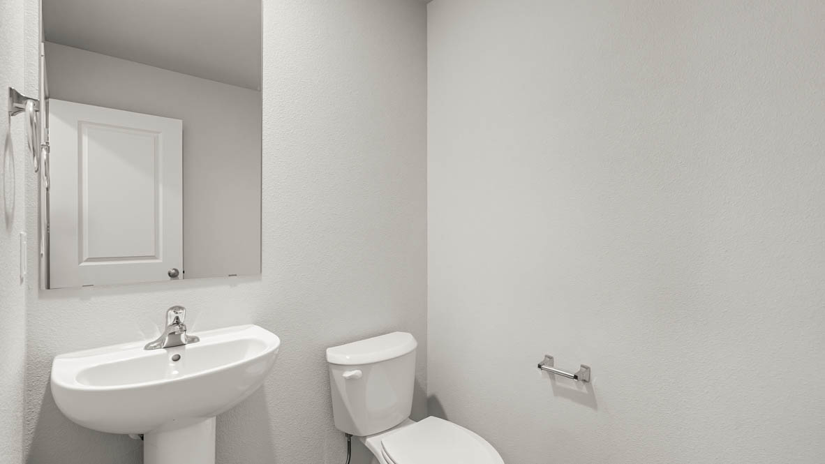 Addysen Park powder room with painted white walls, single sink vanity, toilet, mirror