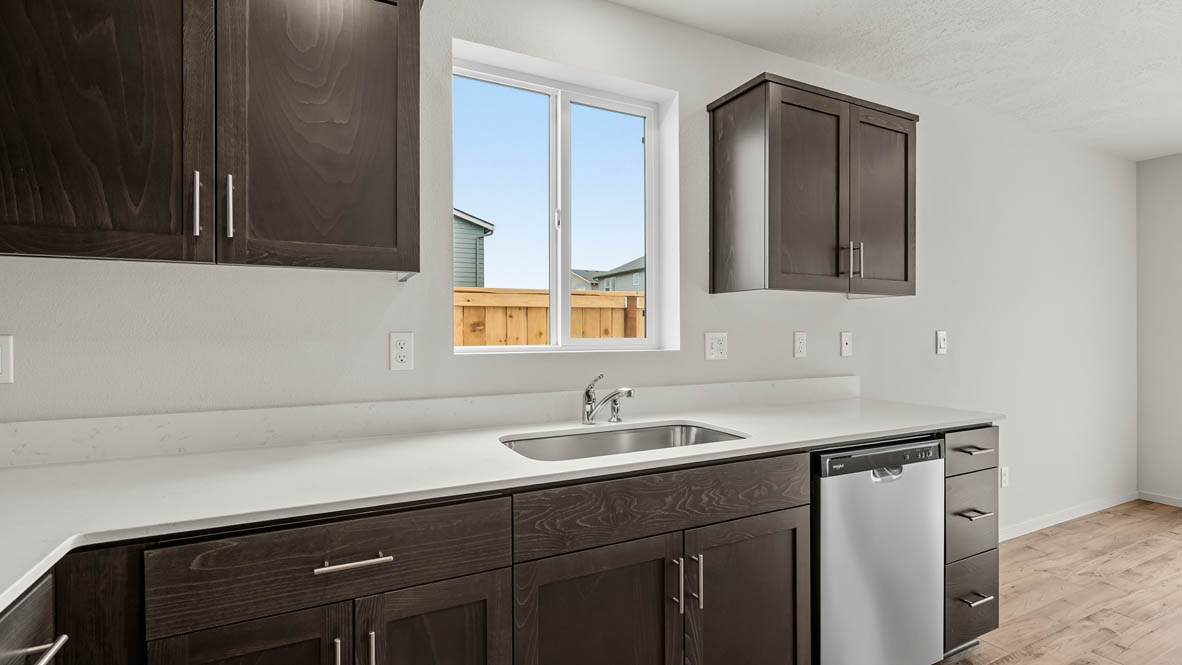 Addysen Park Kitchen with laminate flooring, painted white walls, window, kitchen island, countertops, cabinets