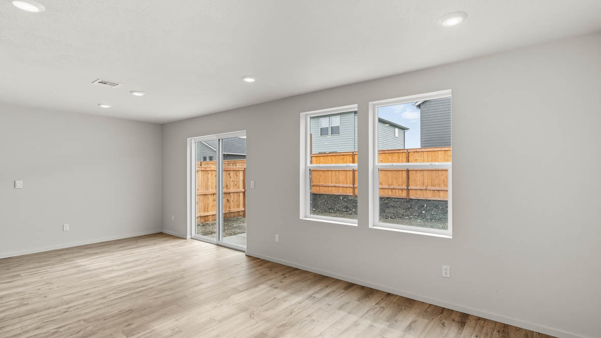 Addysen Park dining room with laminate flooring, white walls, windows, and sliding glass door