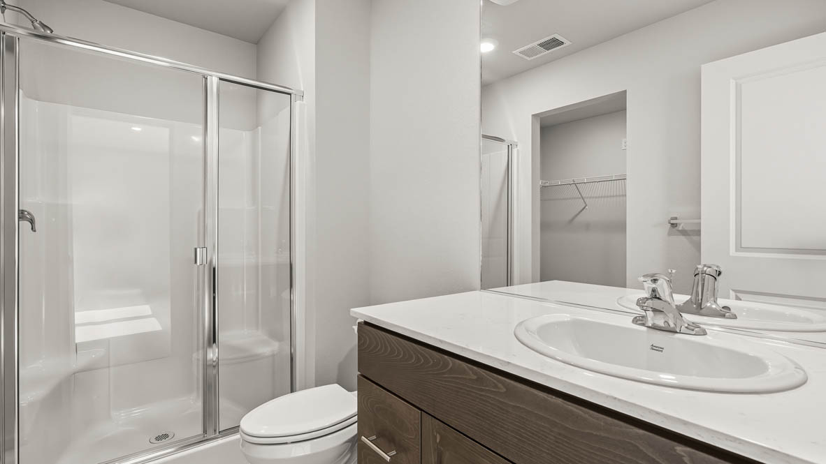 Addysen Park primary bathroom with vanity, mirror, toilet, and shower