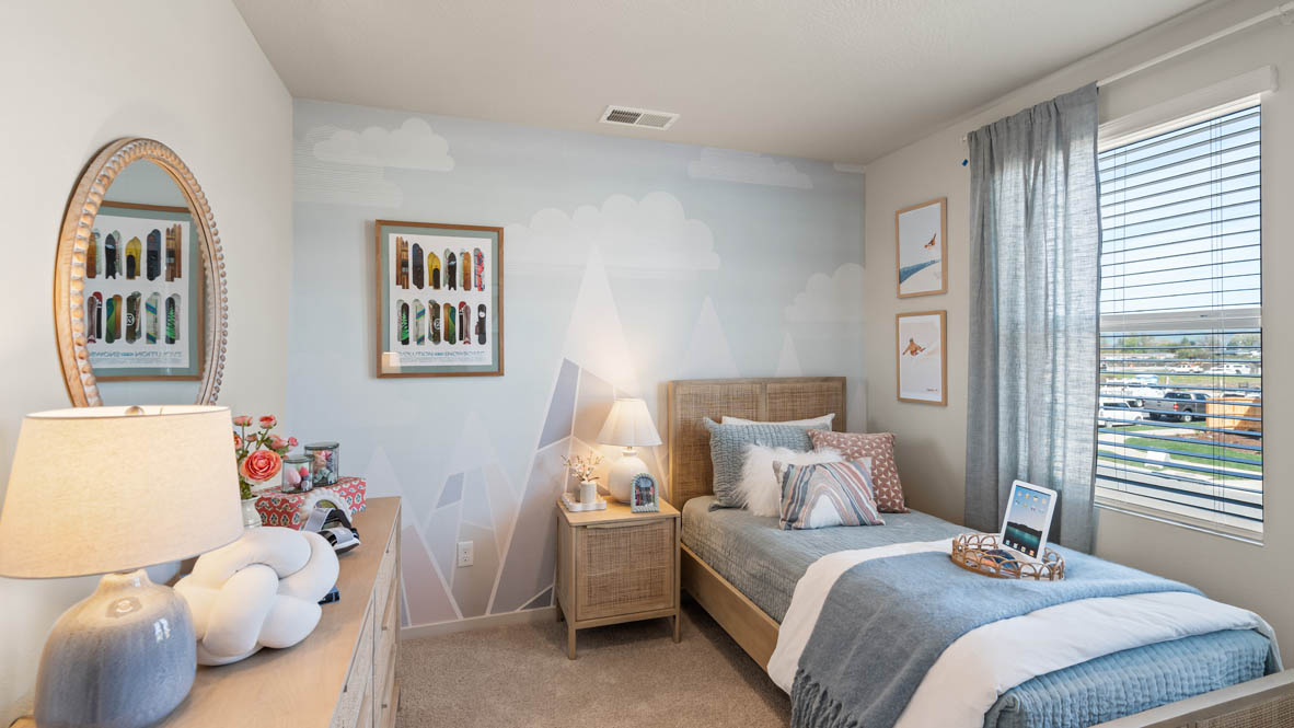 Addysen Park bedroom with twin bed and blue engineering theme and curtains and carpeting