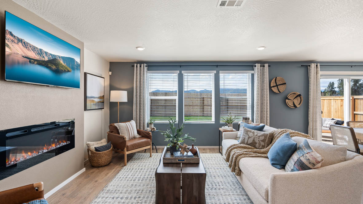 Addysen Park great room with gray accent wall, fireplace with beige paint, white couch, and chairs