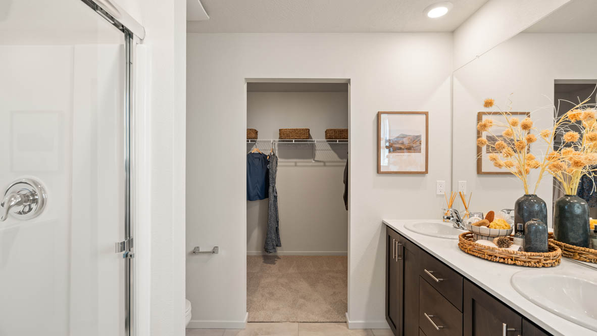 Addysen Park primary bathroom with two sink canity walk in shower and a walk in closet