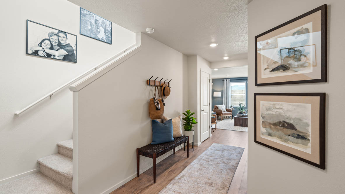 Addysen Park entry with photo frames and an entry bench and long runner rug down the hall