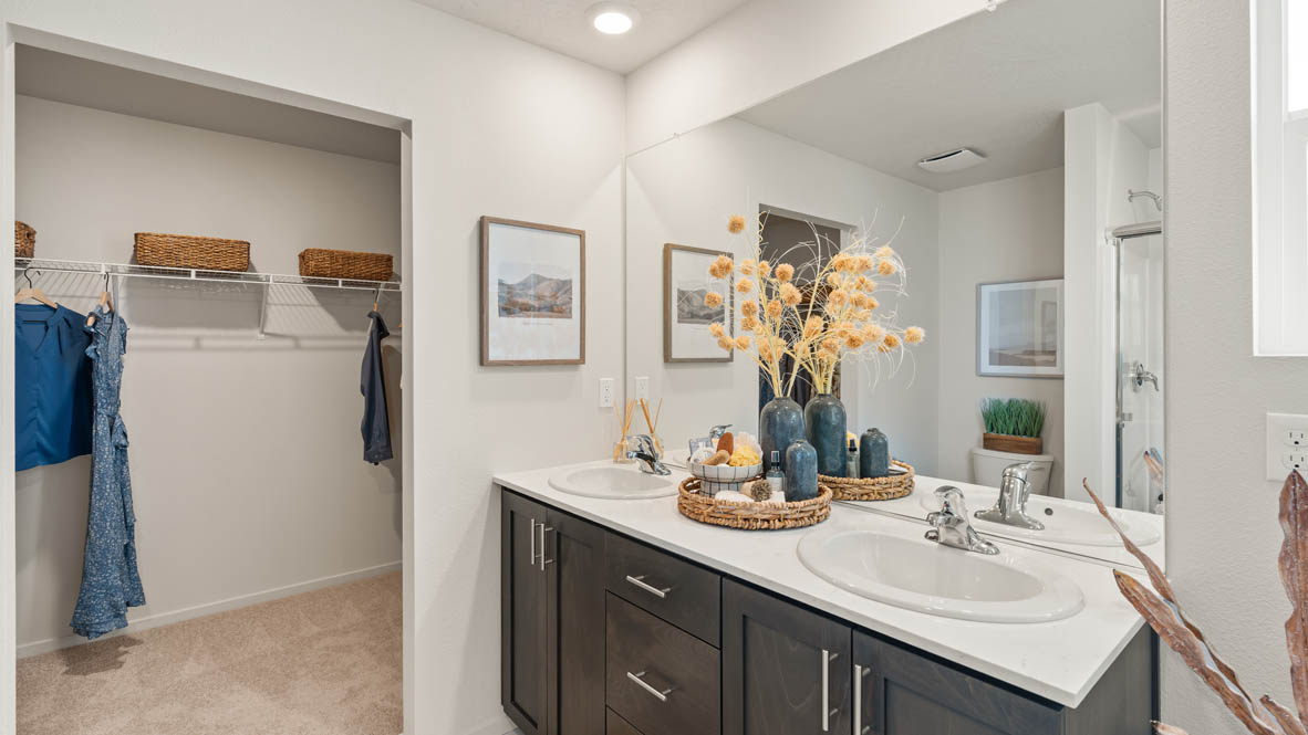 Addysen Park primary bathroom with two sink canity walk in shower and a walk in closet