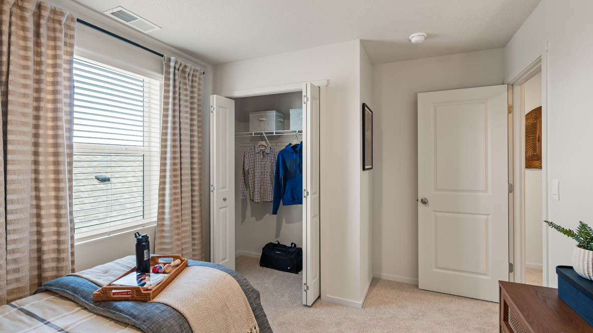 Addysen Park bedroom with twin bed and blue engineering theme and curtains and carpeting