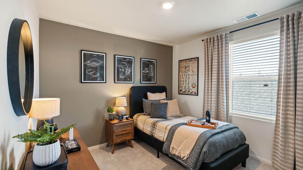 Addysen Park bedroom with twin bed and blue engineering theme and curtains and carpeting