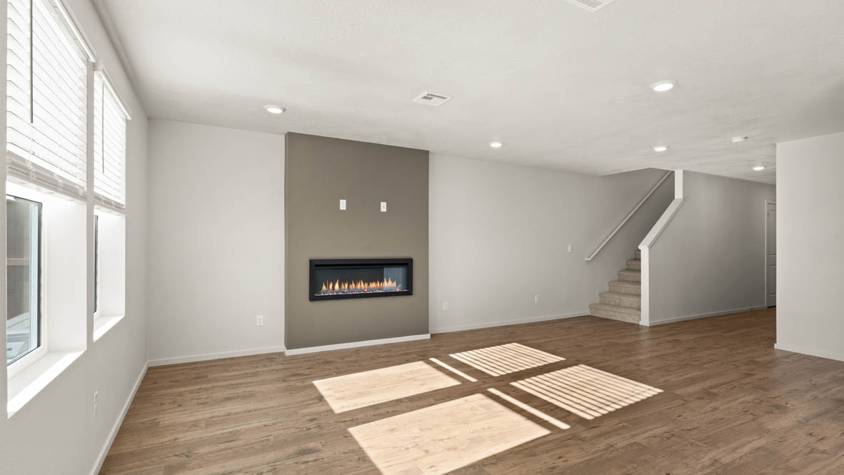 Addysen Park great room with fireplace, laminate flooring, and windows