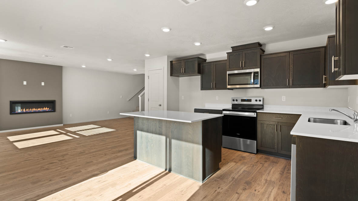 Addysen Park kitchen with laminate flooring, stainless steel appliances, cabinets, window, solid surface countertops