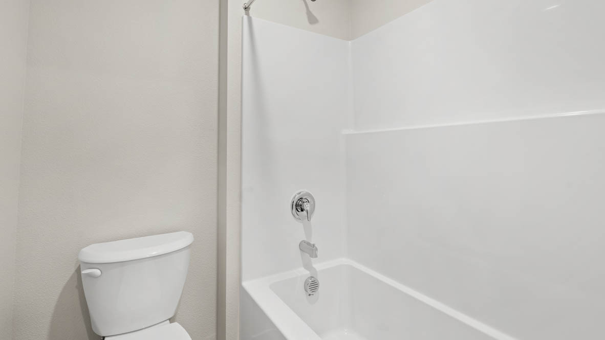 Addysen Park bathroom with solid surface countertops, mirror, and cabinets