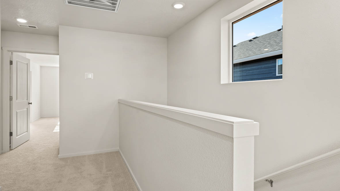 Addysen Park upstairs hallway with white walls and carpet