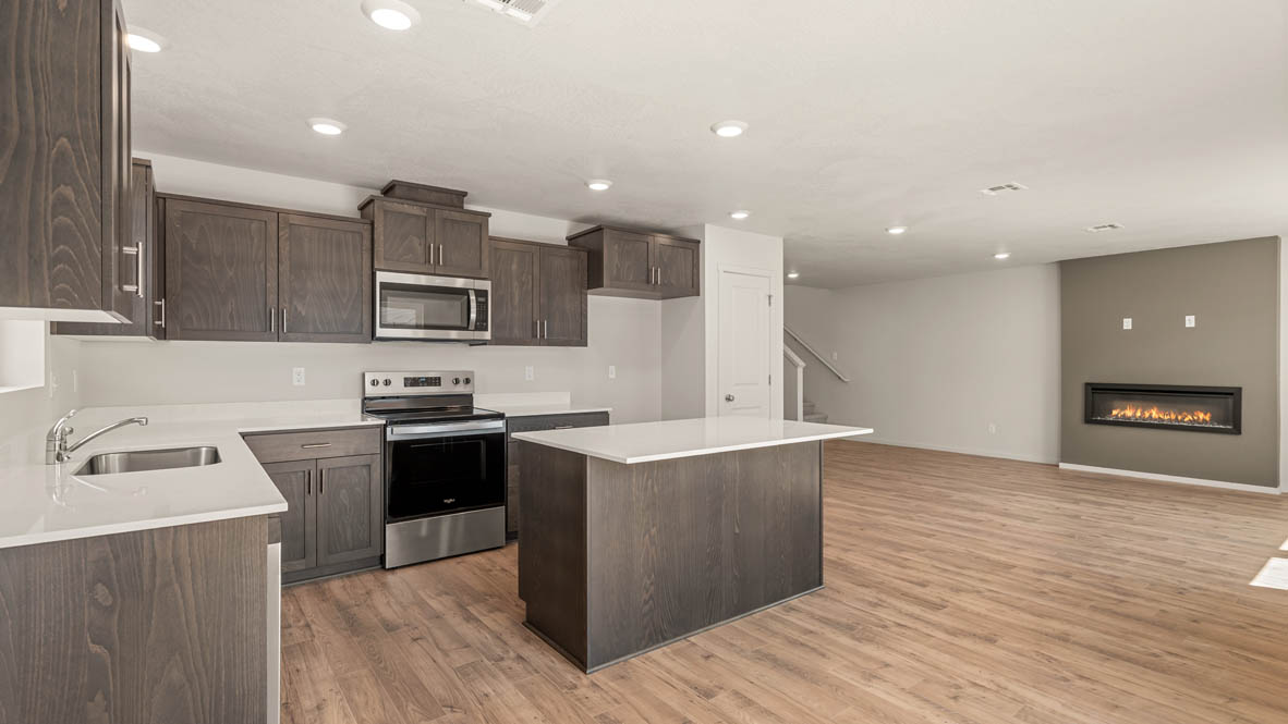 Addysen Park kitchen with laminate flooring, stainless steel appliances, cabinets, window, solid surface countertops