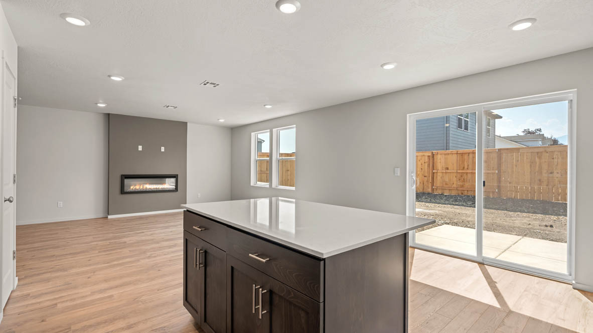 Addysen Park kitchen with laminate flooring, stainless steel appliances, cabinets, window, solid surface countertops