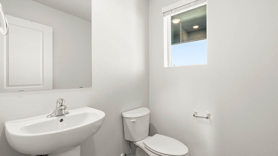 Addysen Park Powder room with white walls, a window, sink vanity, a mirror, and a toilet