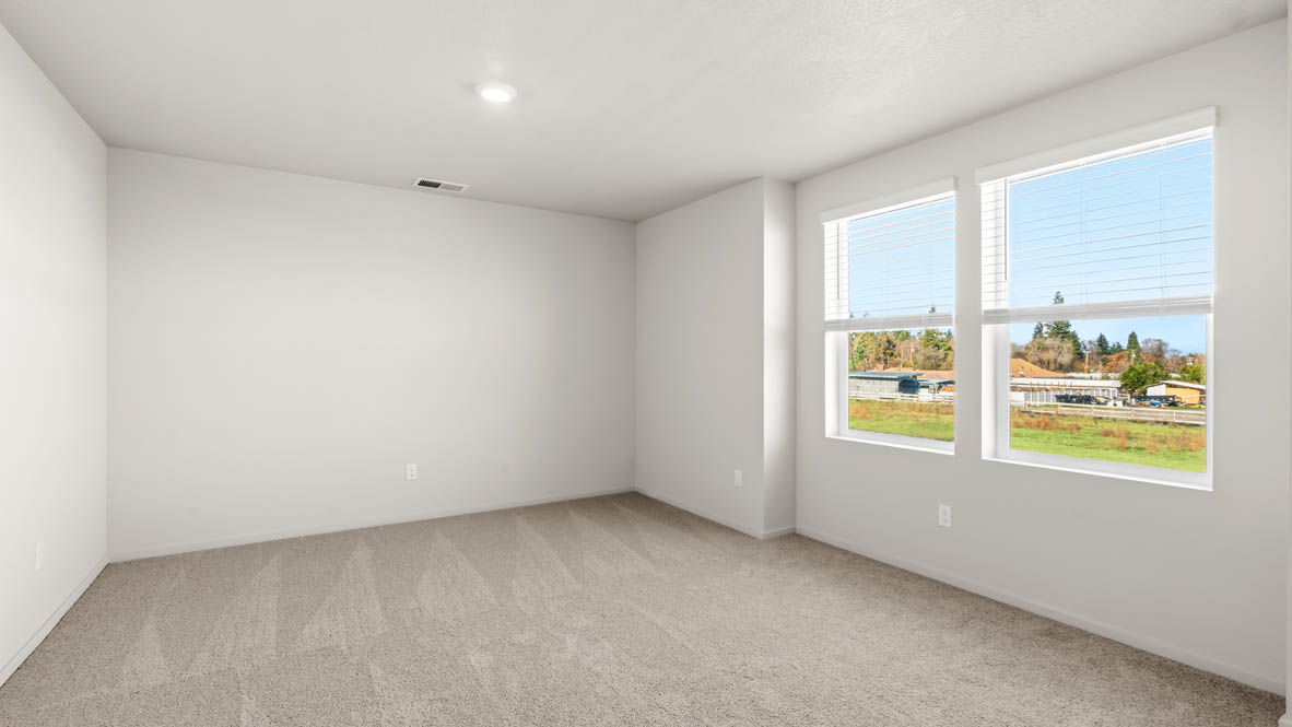 Addysen Park bonus bedroom with white walls, carpet