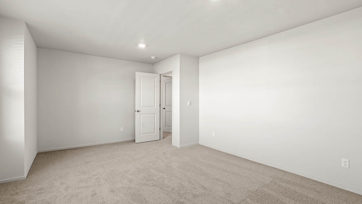 Addysen Park bonus bedroom with white walls, carpet