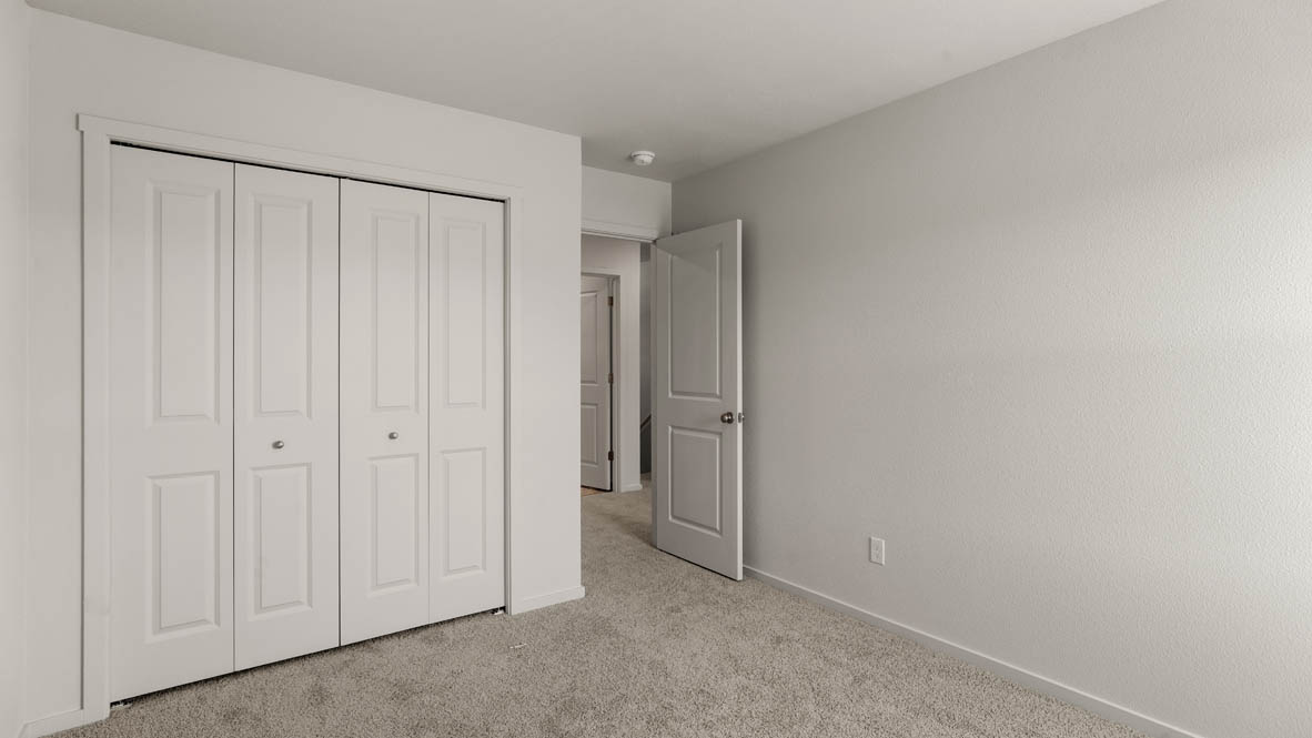 Addysen Park bedroom with white walls, carpet