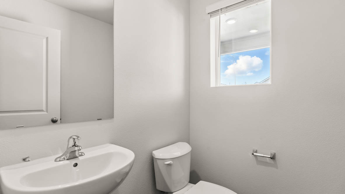 Addysen Park Powder room with white walls, a window, sink vanity, a mirror, and a toilet