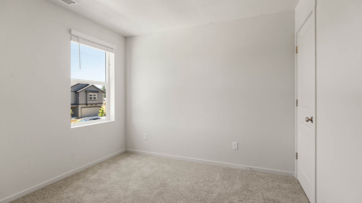 Addysen Park bedroom with white walls, carpet