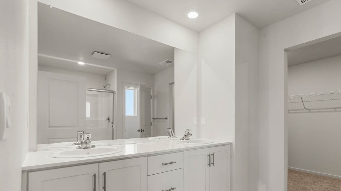 Addysen Park Primary Bathroom with double vanity, walk in shower with sliding glass door, quartz countertops, mirror