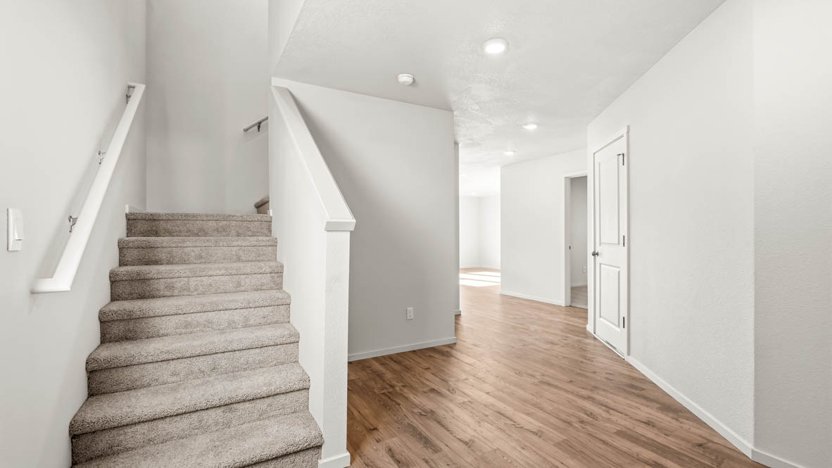 Addysen Park Entry with a staircase, white walls and laminate flooring