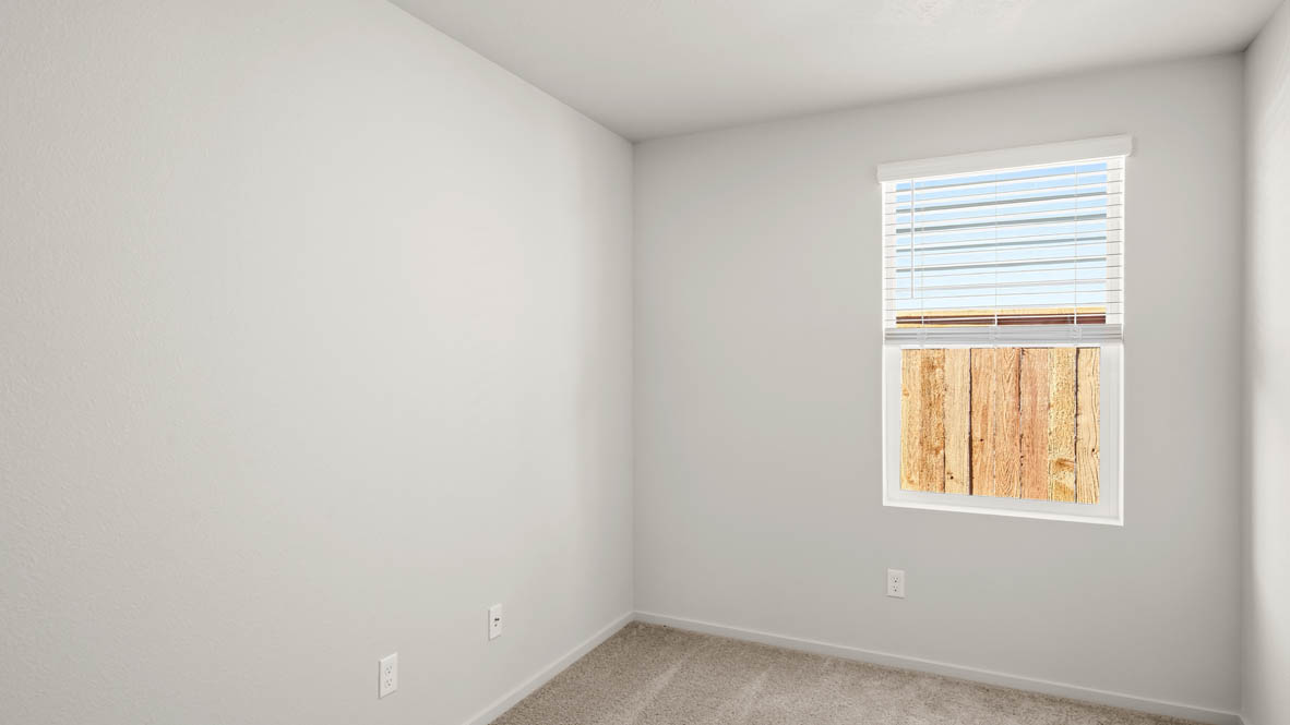 Addysen Park Den with carpet, a window, and white walls