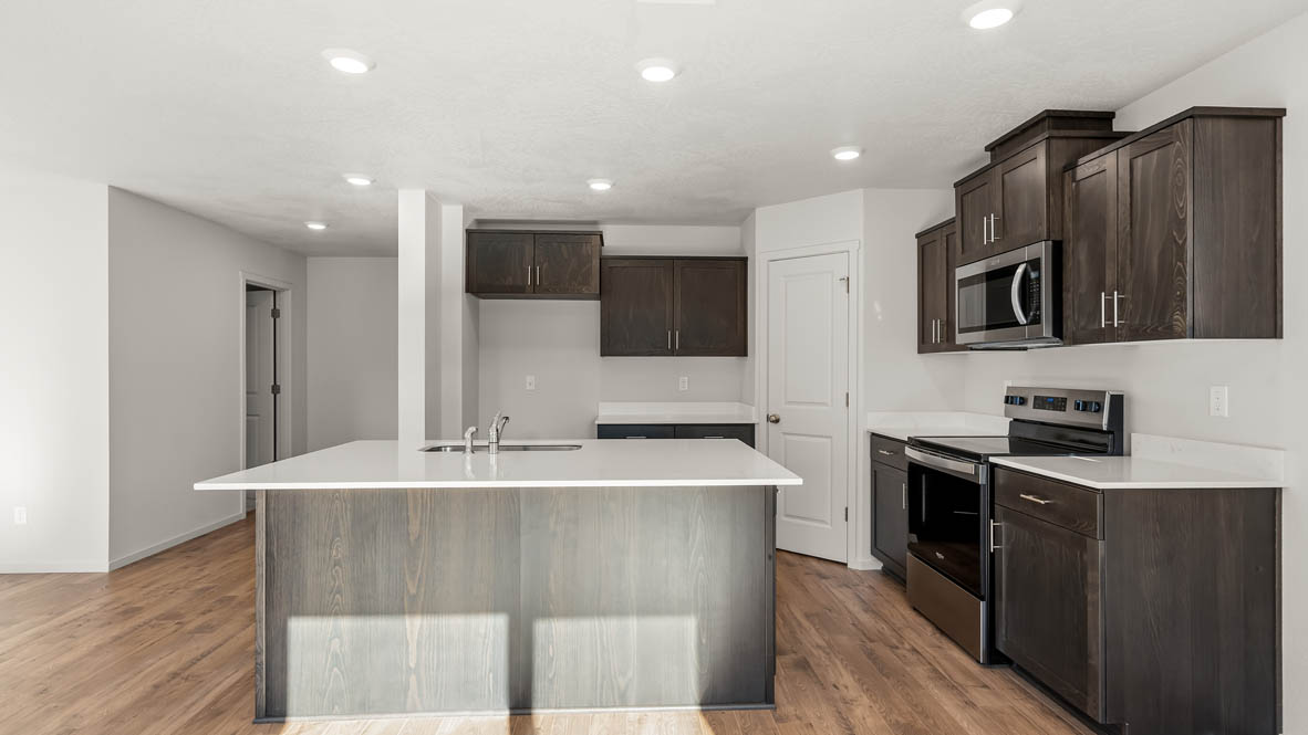 Addysen Park Kitchen with flooring, stainless steel appliances, quartz countertops