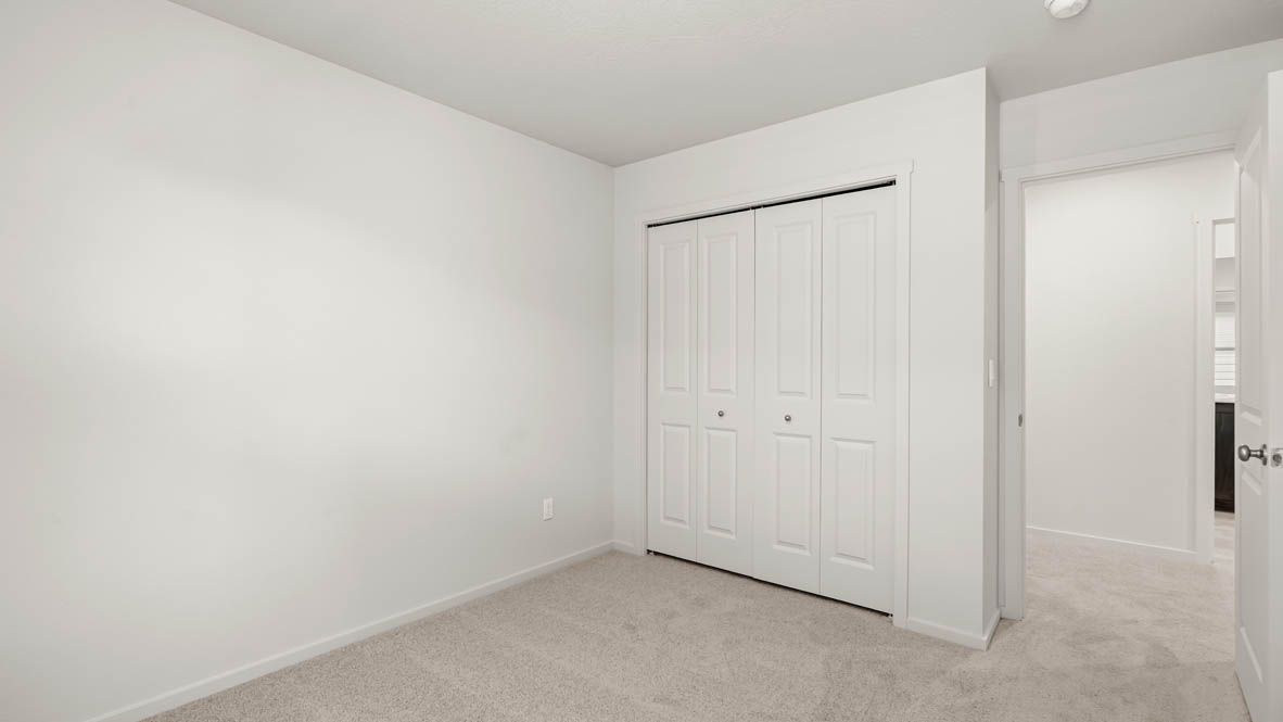 Addysen Park bedroom with white walls, carpet