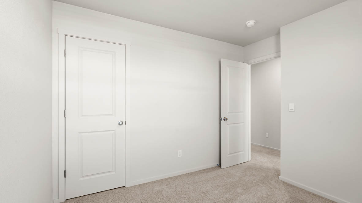 Addysen Park bedroom with white walls, carpet