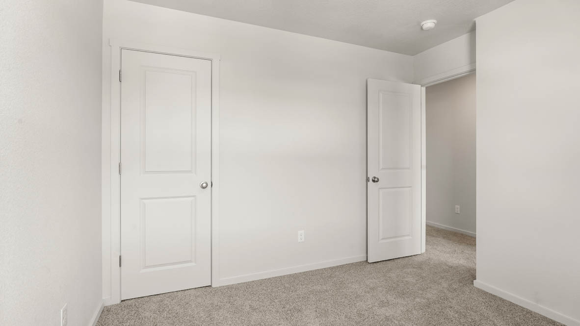 Addysen Park bedroom with white walls, carpet