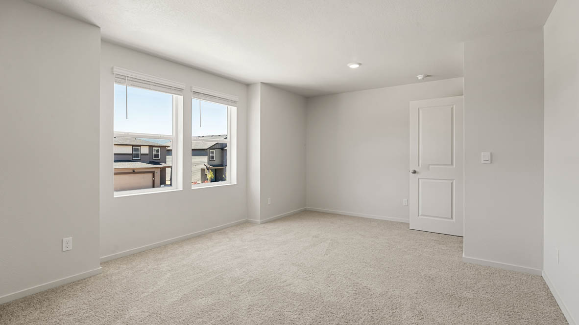 Addysen Park bonus bedroom with white walls, carpet