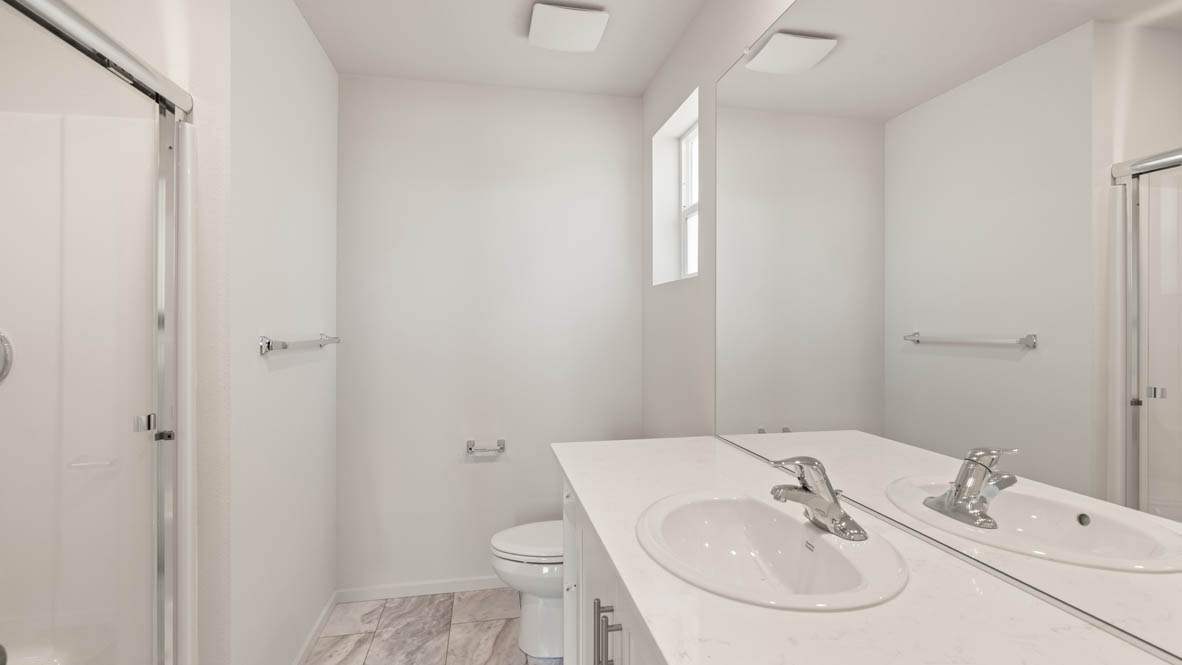 Addysen Park Primary Bathroom with double vanity, walk in shower with sliding glass door, quartz countertops, mirror
