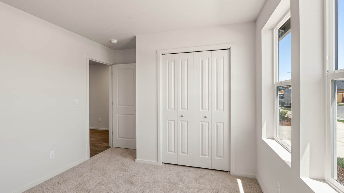 Addysen Park bedroom with white walls, closet, carpet, and windows