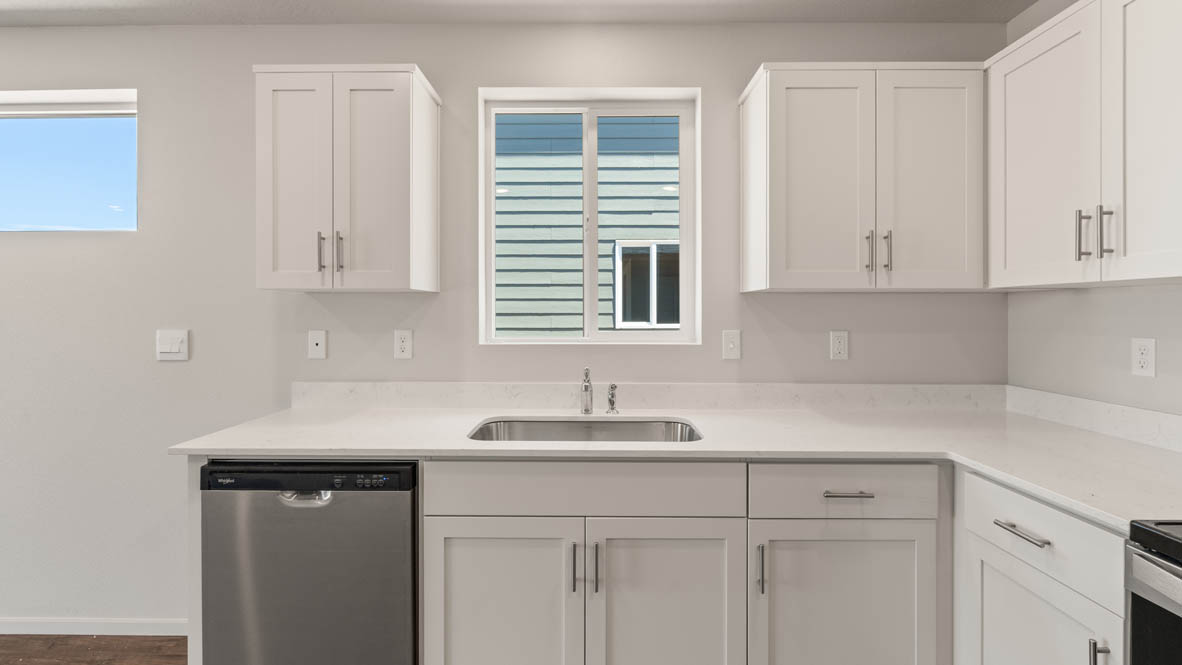 Addysen Park Kitchen with flooring, stainless steel appliances, quartz countertops, and a window