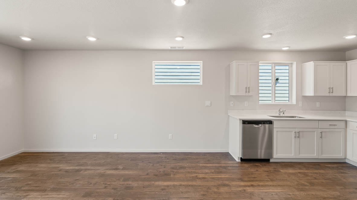 Addysen Park Great room with white walls, windows, and laminate flooring