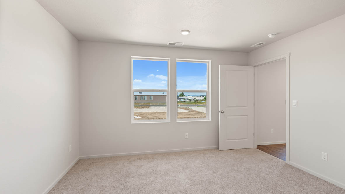 Addysen Park Primary Bedroom with carpet, white walls, and window