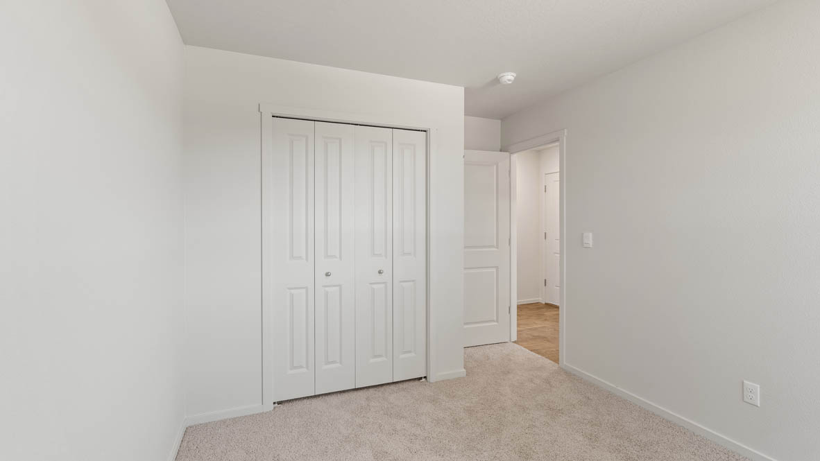 Addysen Park bedroom with white walls, carpet, and door to the hallway