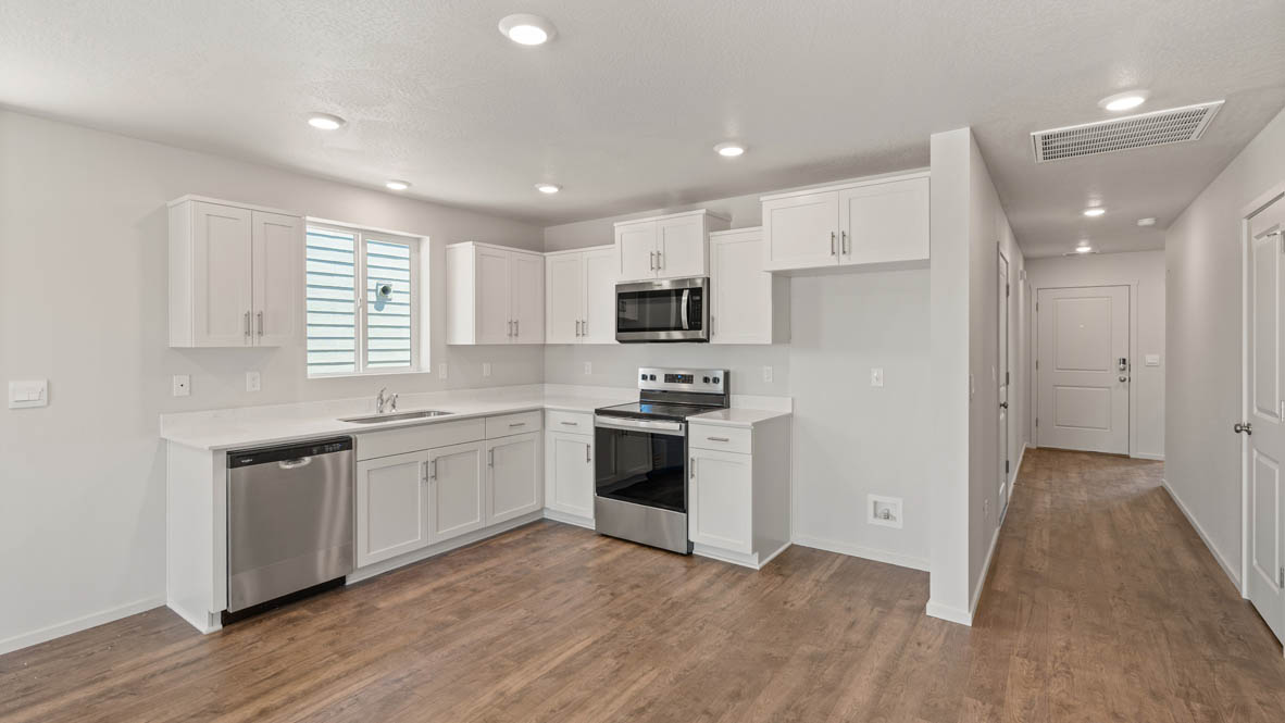 Addysen Park Kitchen with flooring, stainless steel appliances, quartz countertops, and a window