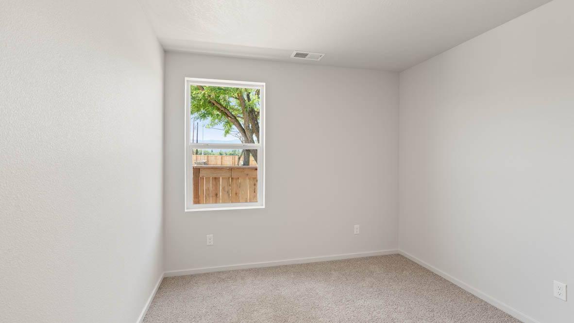 Addysen Park Bedroom with carpet, white walls, and window