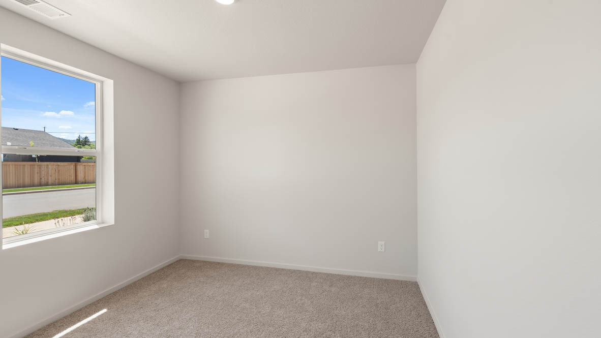 Addysen Park Bedroom with carpet, white walls, and window