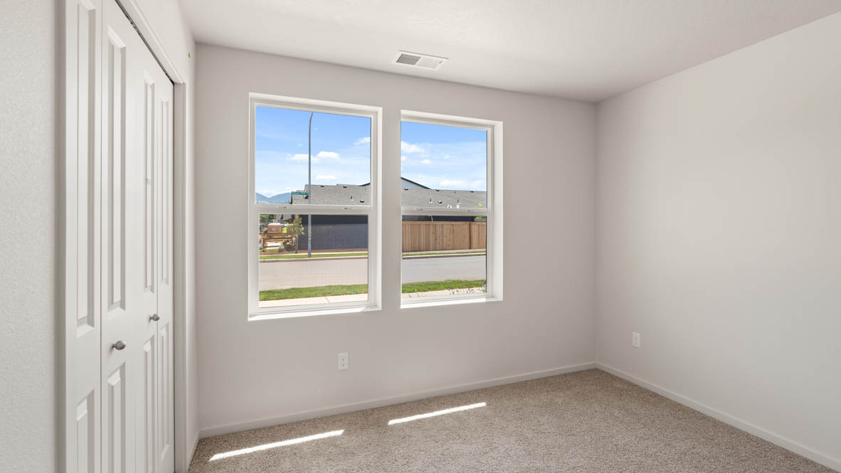 Addysen Park Bedroom with carpet, white walls, and window