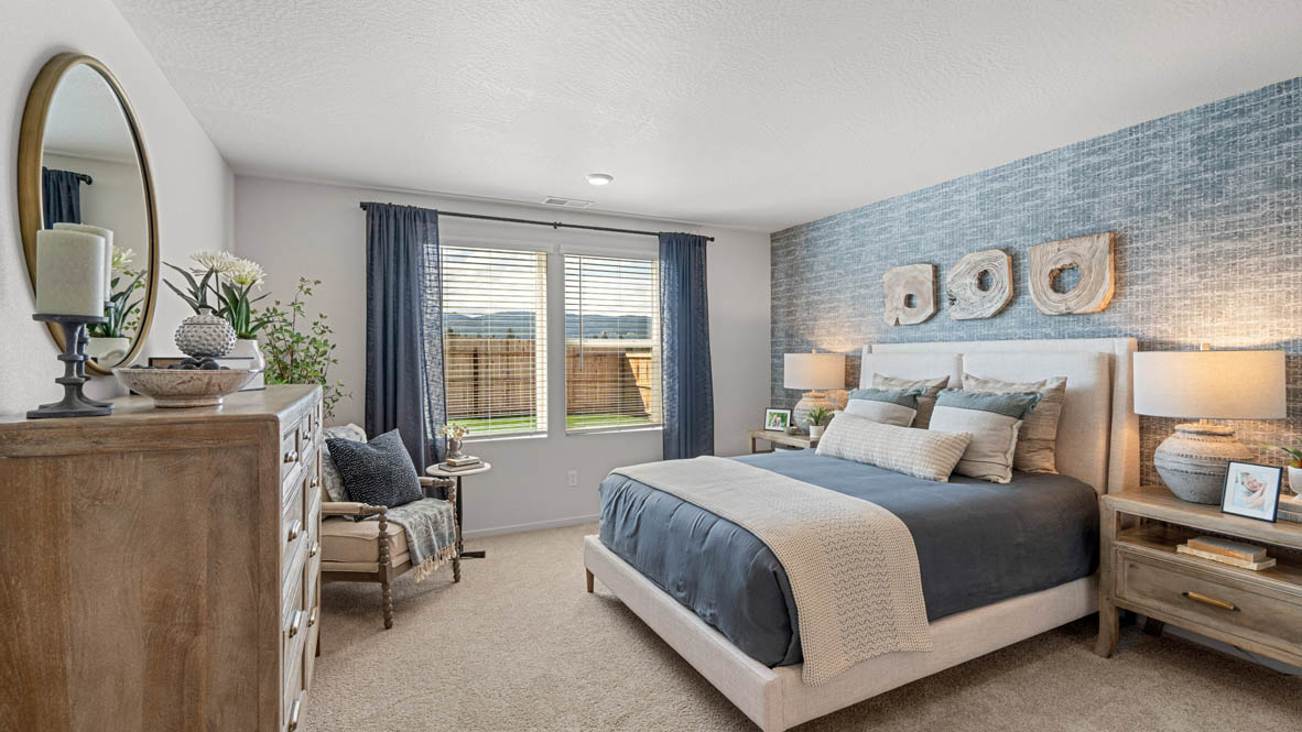 addysen park primary bedroom with blue accent wall and light wooden furniture