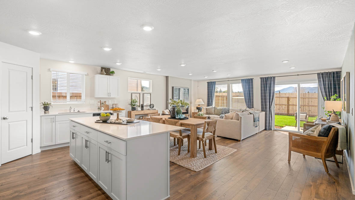 Addysen Park kitchen with island, quartz countertops, and the great room and dining in the background