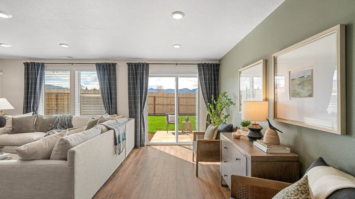 Addysen Park, great room with flooring, couch with pillows, and dining room in the background with the sliding glass door